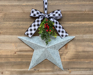 Farmhouse holiday decor, galvanized metal star with bow, Christmas door hanger with greenery and red berries